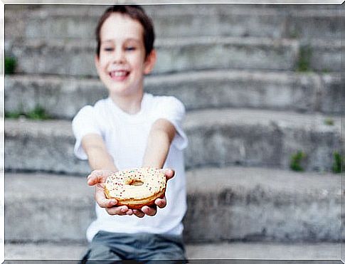 boy holding a donut