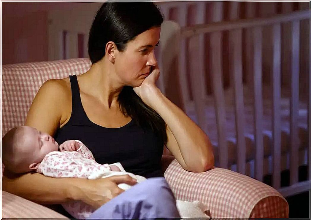 Woman trying to help her baby to sleep at night.