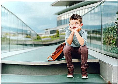 sad boy with school bag