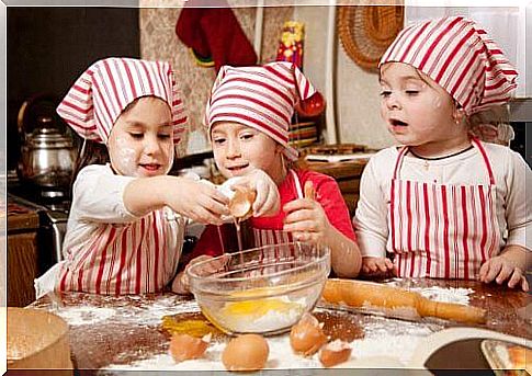 children opening eggs in the kitchen