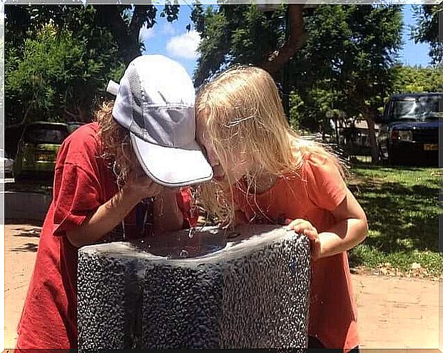 Children drinking water on a summer afternoon