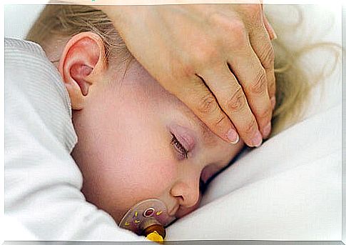 Mother with hand on baby's head